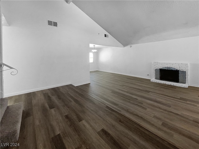 unfurnished living room with lofted ceiling, wood-type flooring, and a fireplace