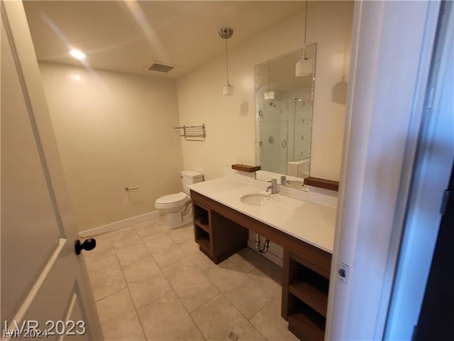 bathroom with vanity with extensive cabinet space, toilet, and tile flooring