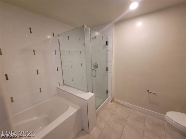 bathroom featuring toilet, shower with separate bathtub, and tile floors