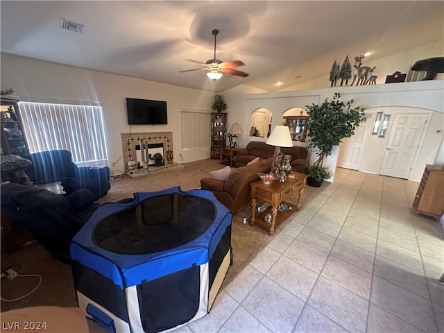 living room with ceiling fan, light tile flooring, and lofted ceiling