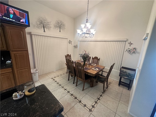 dining room featuring vaulted ceiling, light tile floors, and an inviting chandelier