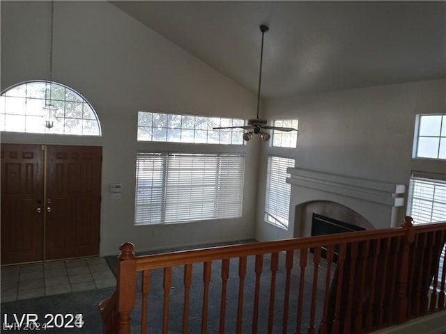 tiled entrance foyer with high vaulted ceiling and ceiling fan