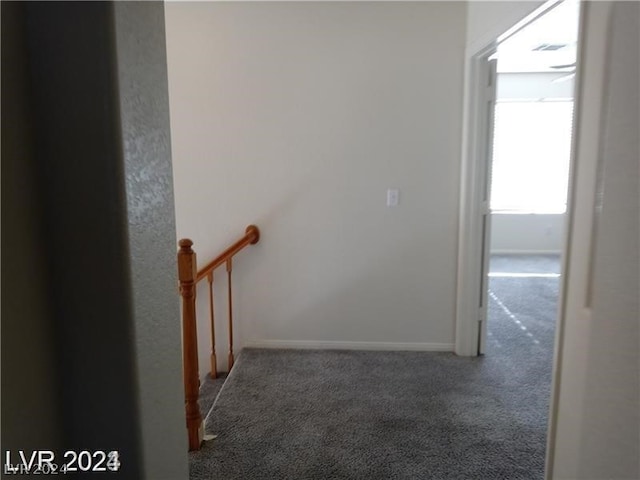 hallway featuring dark colored carpet