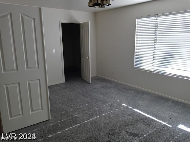 interior space with dark colored carpet