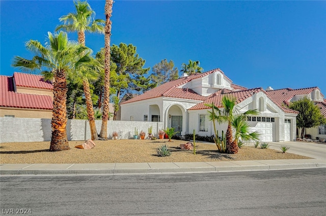 mediterranean / spanish-style house with a garage