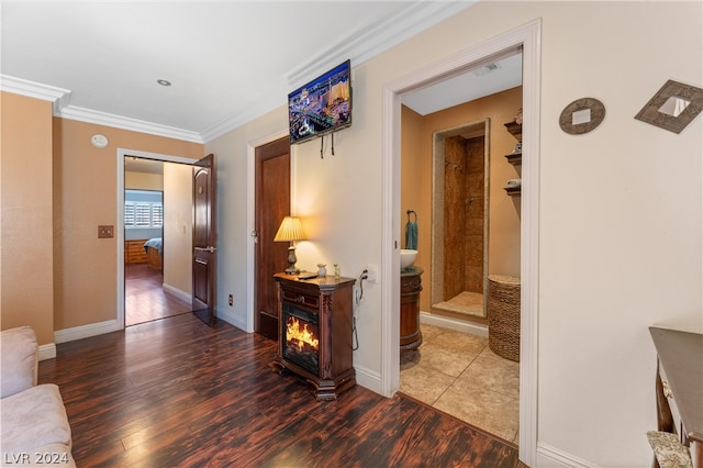 hallway with dark hardwood / wood-style floors and crown molding