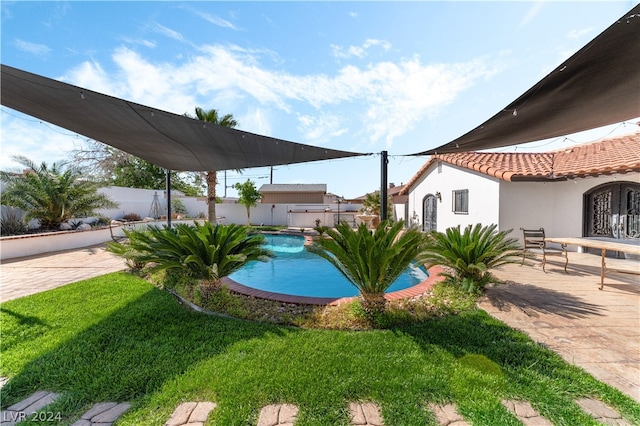 view of yard featuring a fenced in pool, french doors, and a patio area