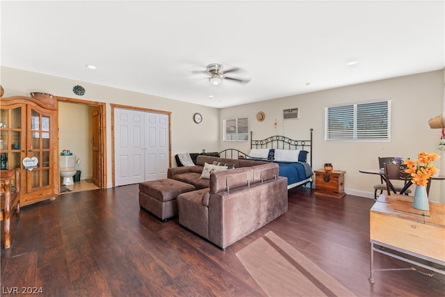 living room featuring dark wood-type flooring and ceiling fan