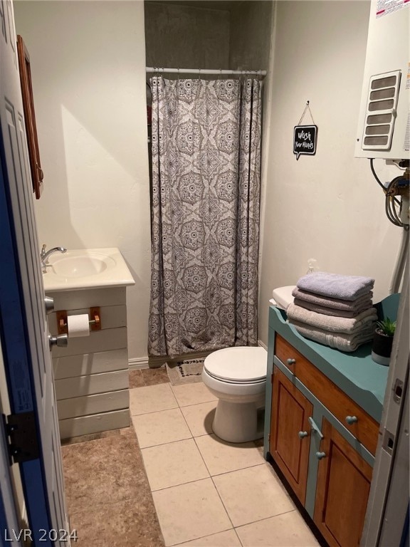 bathroom with vanity, toilet, a shower with shower curtain, and tile patterned floors