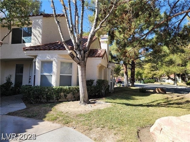 view of side of home with a lawn