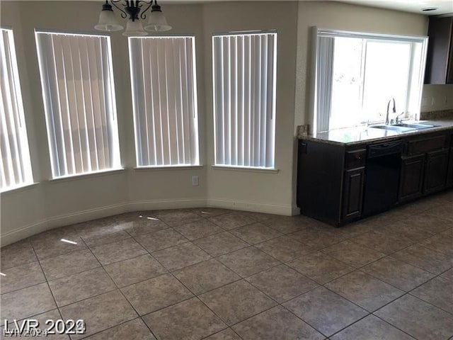 kitchen with black dishwasher, tile flooring, and sink