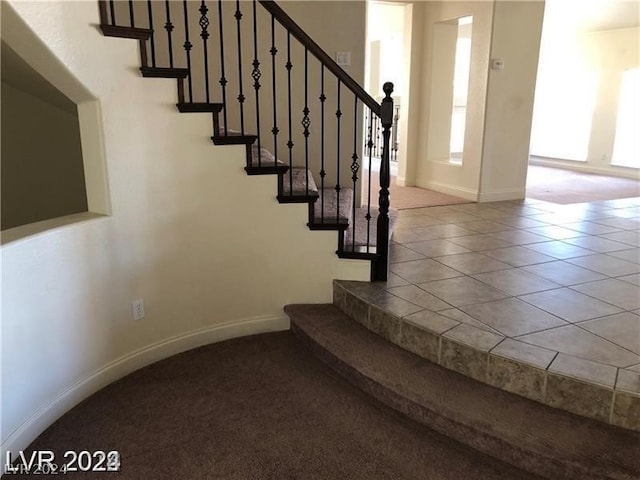 staircase with light carpet