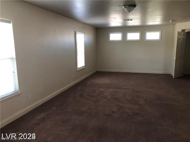 carpeted empty room with a wealth of natural light