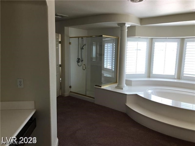 bathroom featuring ornate columns and independent shower and bath