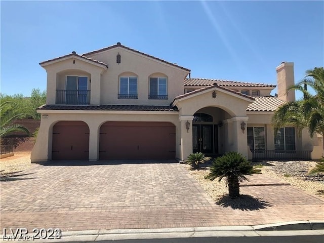 mediterranean / spanish-style house with a garage