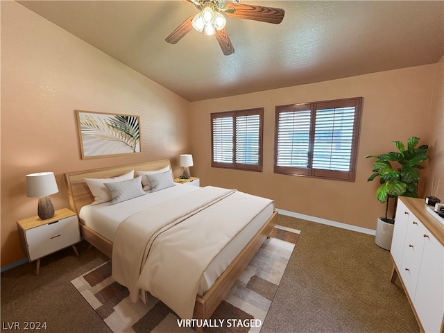 bedroom featuring dark carpet, vaulted ceiling, and multiple windows