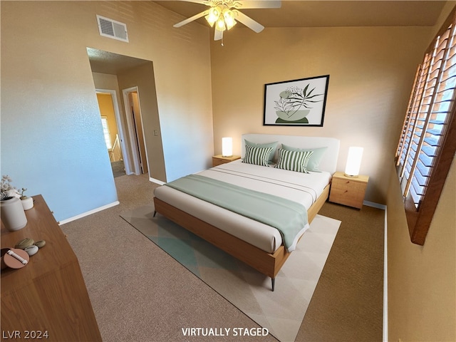 carpeted bedroom featuring vaulted ceiling and ceiling fan