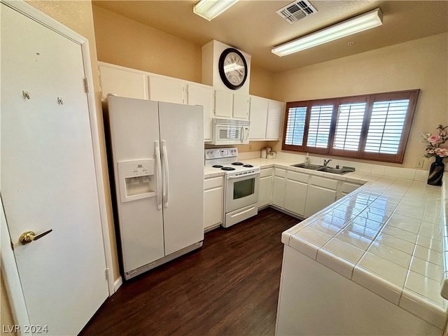 kitchen with tile counters, white appliances, dark hardwood / wood-style floors, white cabinetry, and sink