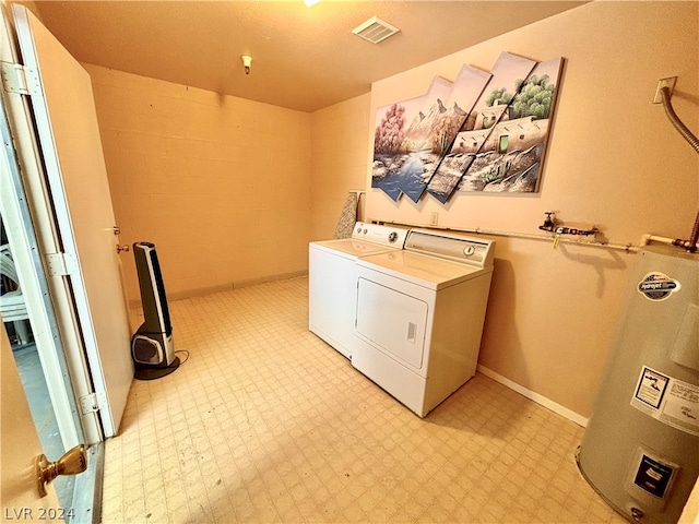 laundry area featuring washer and dryer, water heater, and light tile floors