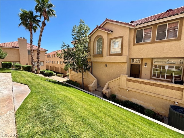 exterior space with central air condition unit and a front yard