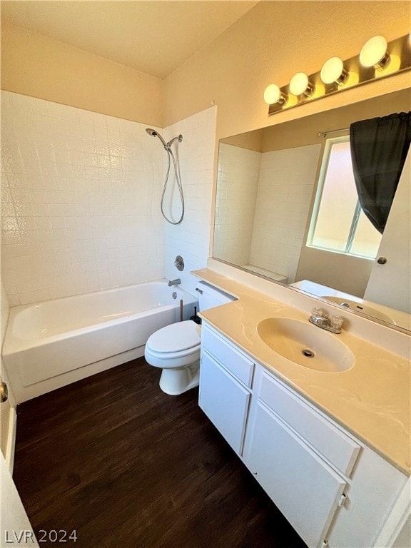 full bathroom featuring wood-type flooring, vanity, toilet, and tiled shower / bath combo