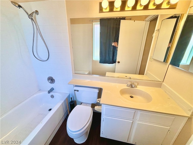 full bathroom with toilet, tiled shower / bath combo, and large vanity