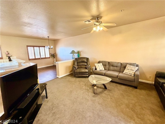 carpeted living room with a textured ceiling and ceiling fan