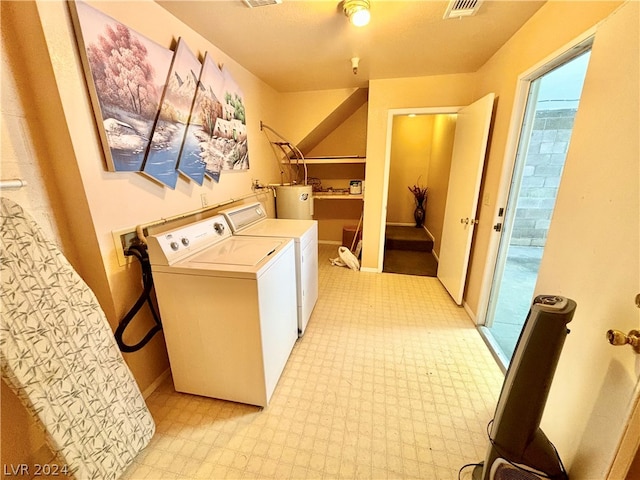 laundry room with washer hookup, water heater, and separate washer and dryer