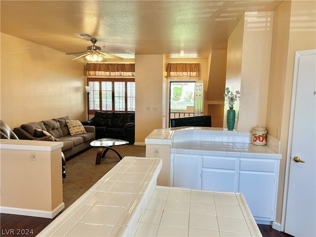 living room featuring ceiling fan and carpet floors