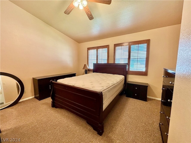 bedroom featuring lofted ceiling, ceiling fan, and light carpet