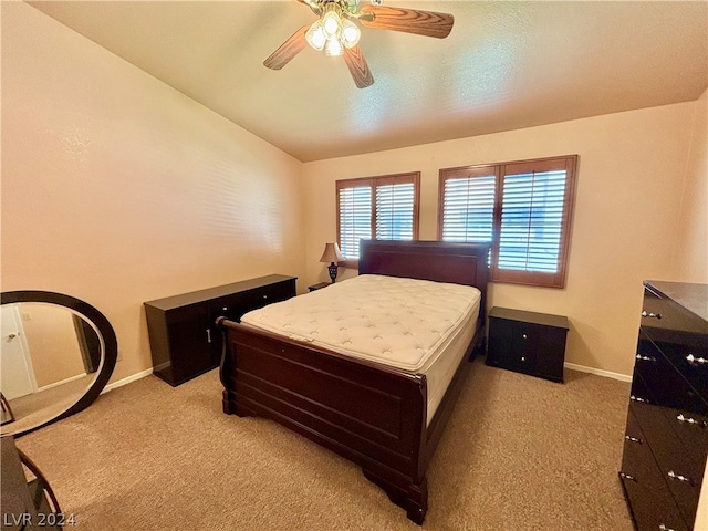 bedroom with light colored carpet, ceiling fan, and lofted ceiling