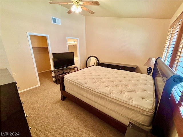 carpeted bedroom with a closet, ceiling fan, and a walk in closet