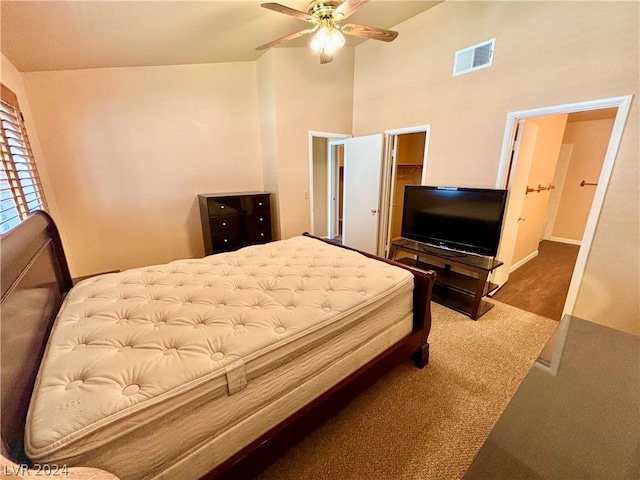 bedroom featuring ceiling fan, high vaulted ceiling, and dark carpet