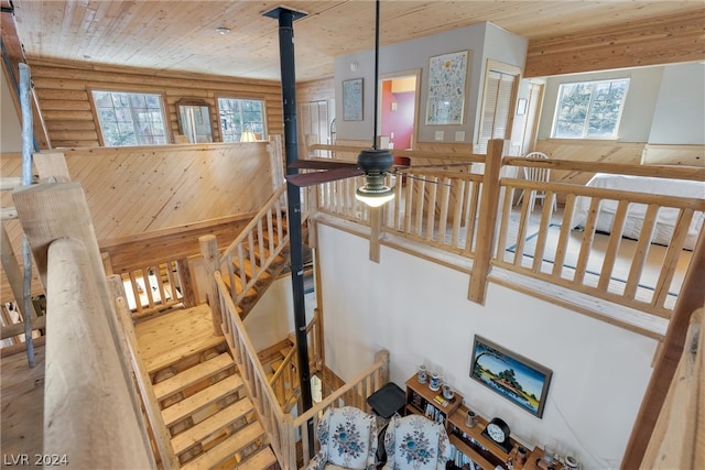 staircase featuring a wood stove and wooden ceiling