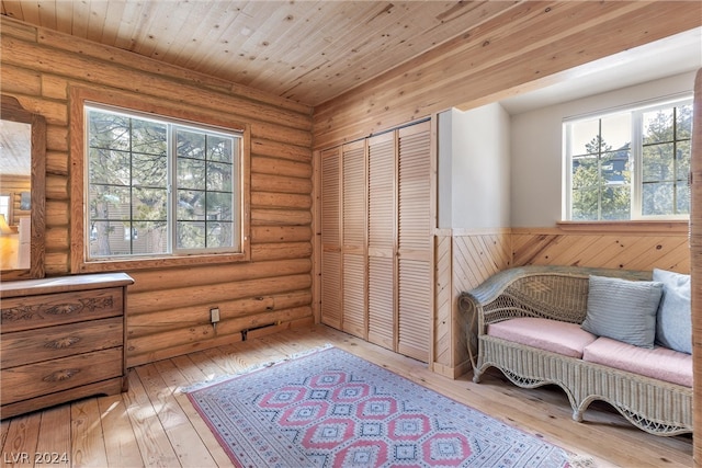 living area featuring wood ceiling, log walls, and light wood-type flooring