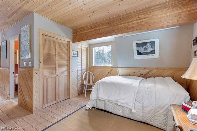 bedroom featuring wooden ceiling, light wood-type flooring, and a closet