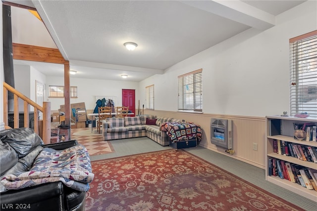 living room featuring light colored carpet and a textured ceiling