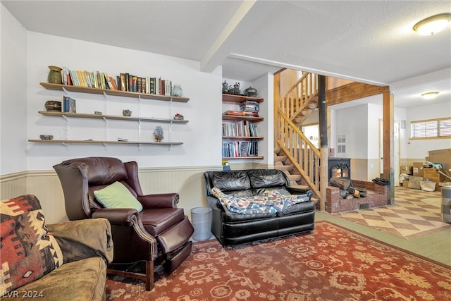 living room with carpet flooring, beam ceiling, and a textured ceiling