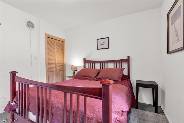 bedroom featuring a closet and dark carpet