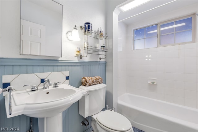 bathroom with bathtub / shower combination, tasteful backsplash, and toilet