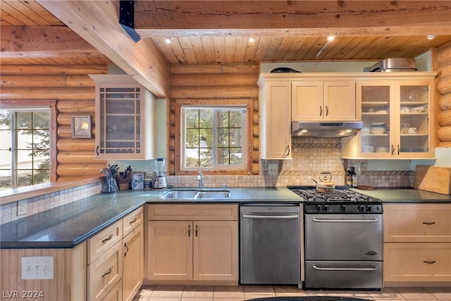 kitchen featuring gas stove, tasteful backsplash, log walls, and dishwasher