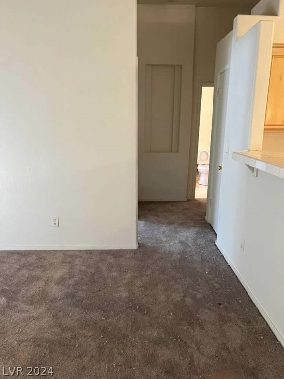 empty room featuring dark colored carpet