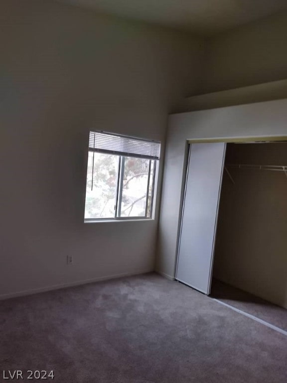 unfurnished bedroom featuring a closet and carpet