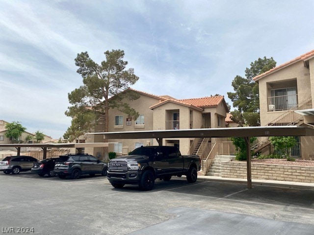 view of parking / parking lot with a carport