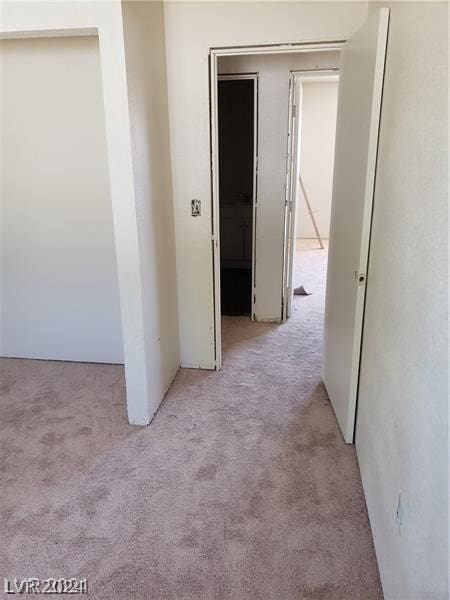 corridor with light colored carpet