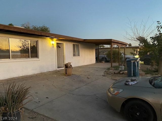 back of house featuring a carport