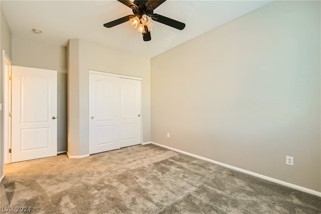 unfurnished bedroom with a closet, ceiling fan, and carpet floors