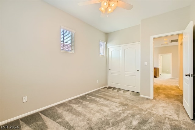 unfurnished bedroom featuring a closet, ceiling fan, and carpet floors