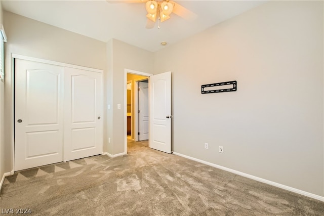 unfurnished bedroom featuring a closet, ceiling fan, and carpet floors