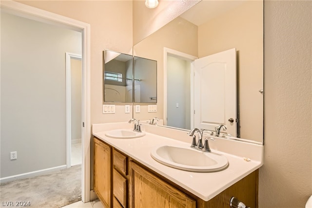 bathroom featuring large vanity and double sink